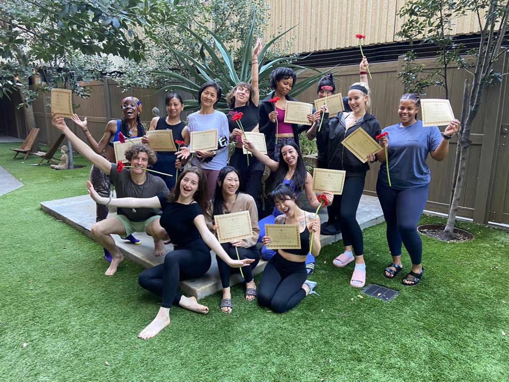Deep Method graduates holding certificates and flowers
