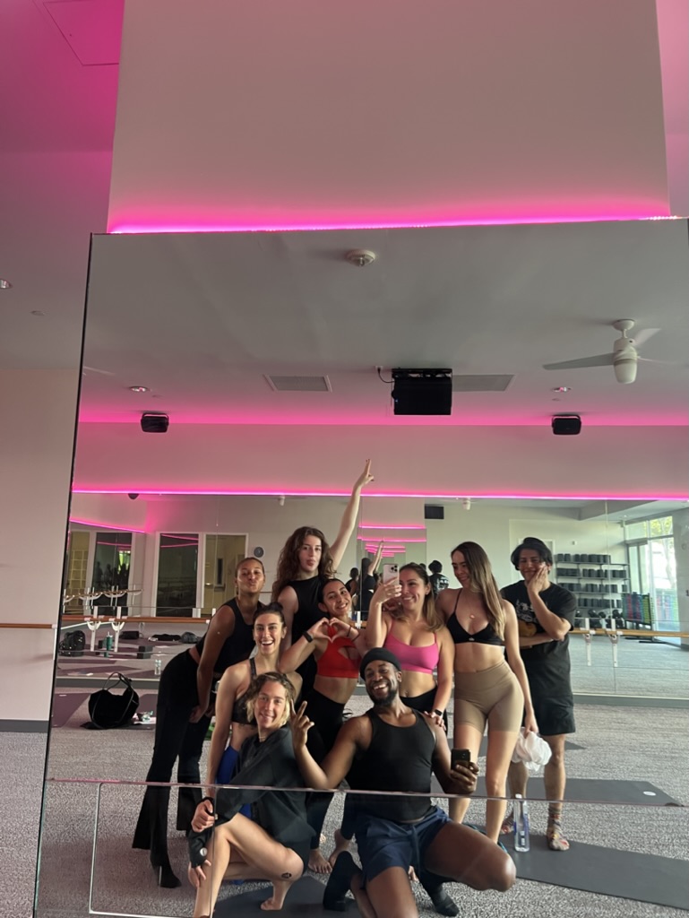 Training group in studio with pink lights